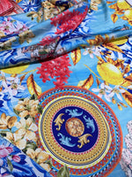 Majolica Sicilian print fabric with vibrant traditional Sicilian patterns and bright colors on a soft blue background