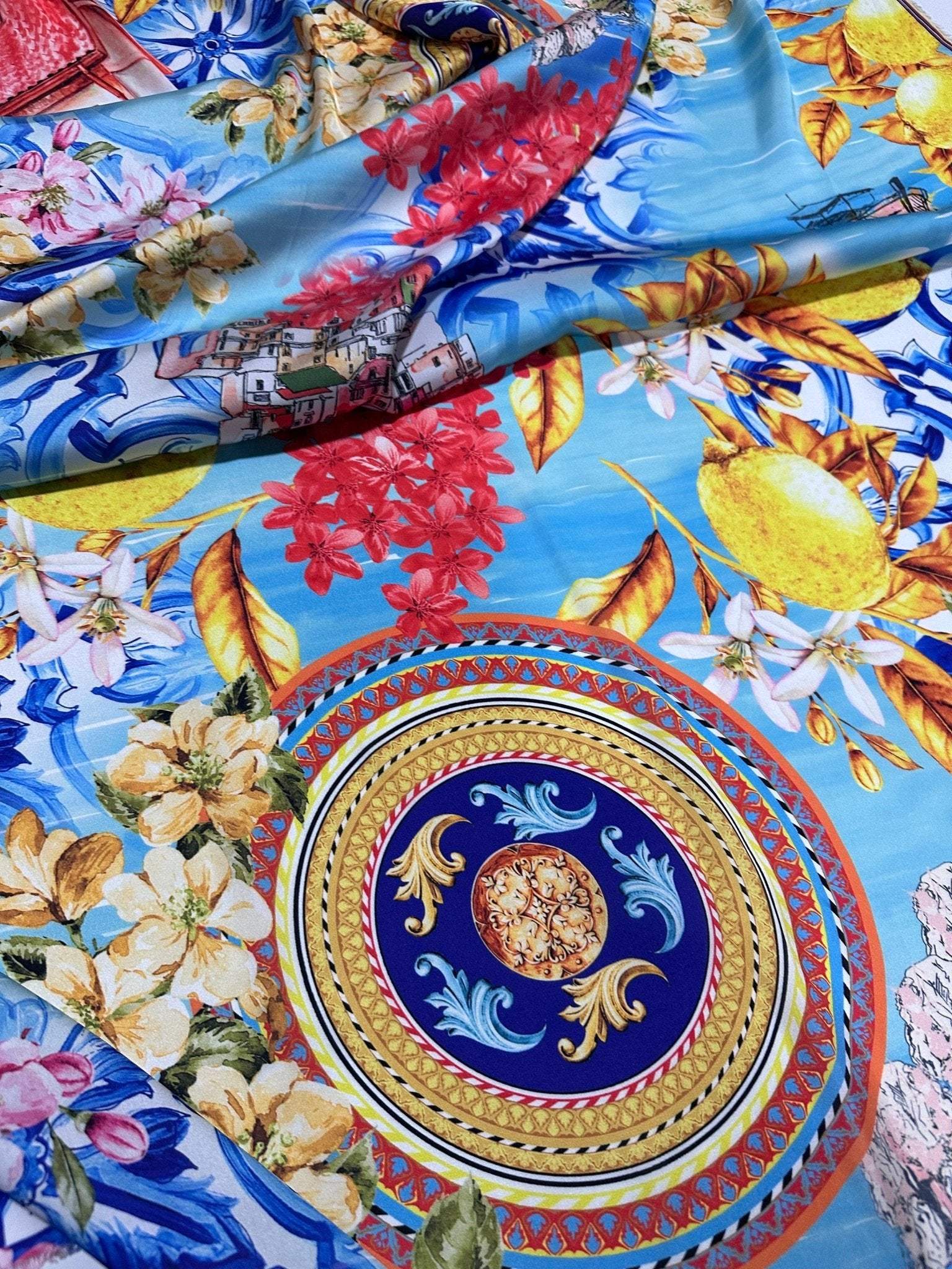Majolica Sicilian print fabric with vibrant traditional Sicilian patterns and bright colors on a soft blue background