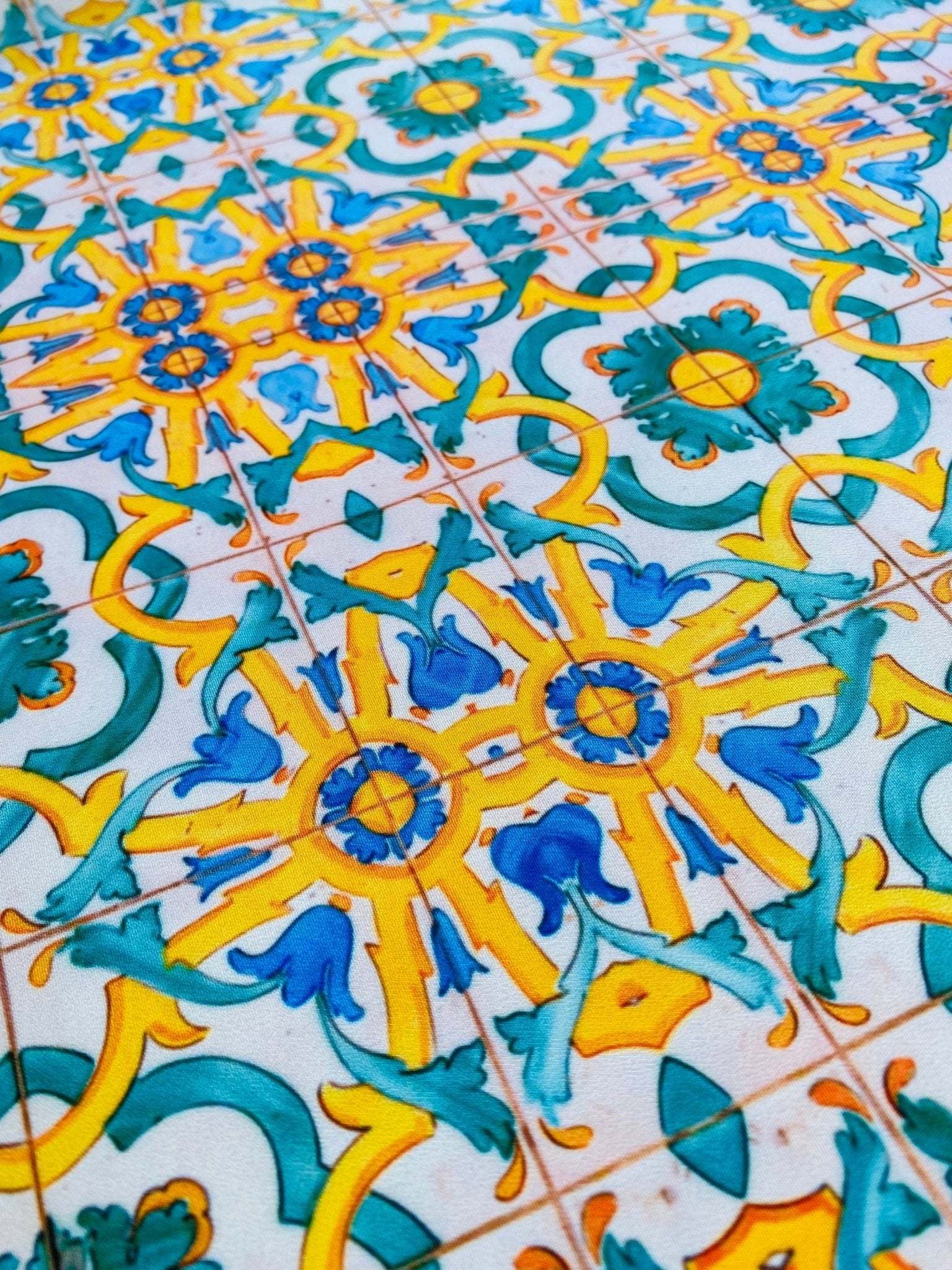 Yellow, blue, and green Mediterranean tile pattern fabric with intricate geometric design