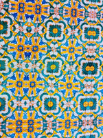 Yellow, blue, and green Mediterranean tile print fabric with intricate geometric pattern