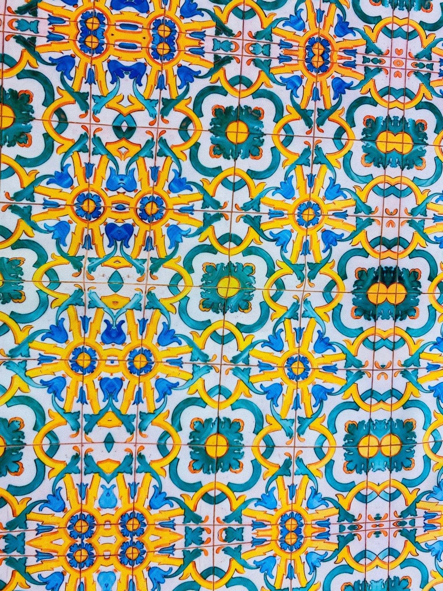 Yellow, blue, and green Mediterranean tile print fabric with intricate geometric pattern