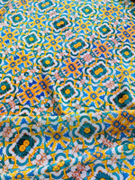Yellow, blue, and green Mediterranean tile print fabric with intricate geometric pattern and vibrant colors, 150cm width