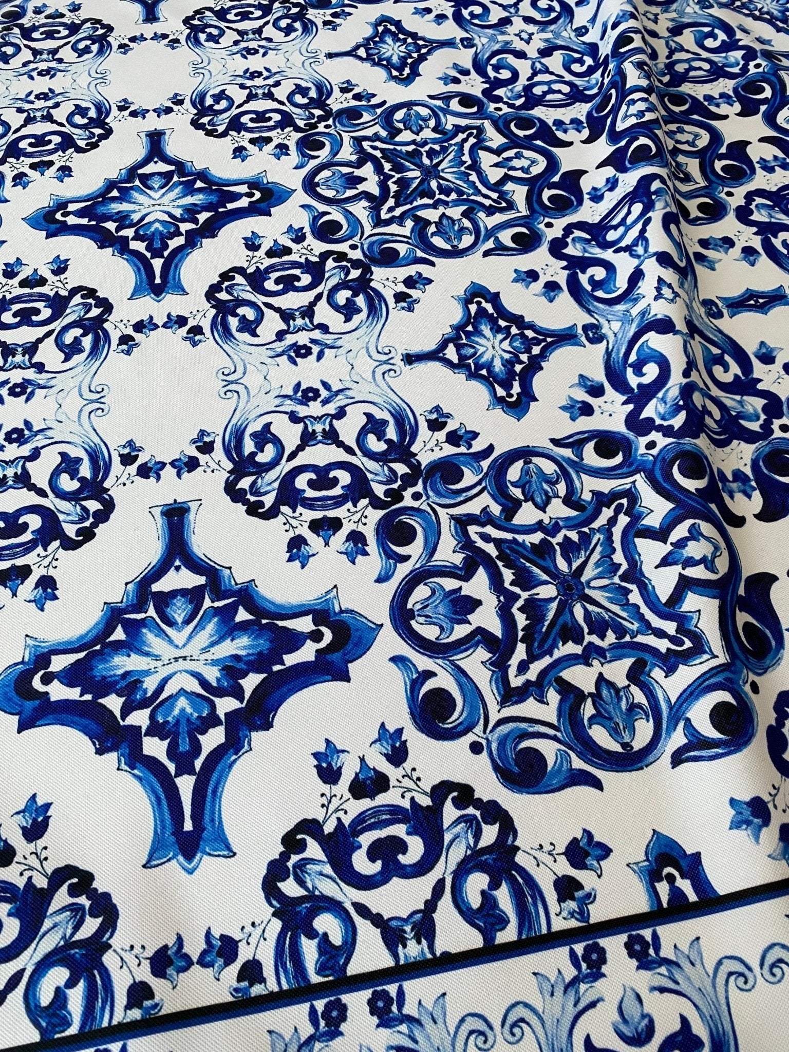 Majolica pattern outdoor fabric with blue intricate design on white background, weather-resistant upholstery material for outdoor use