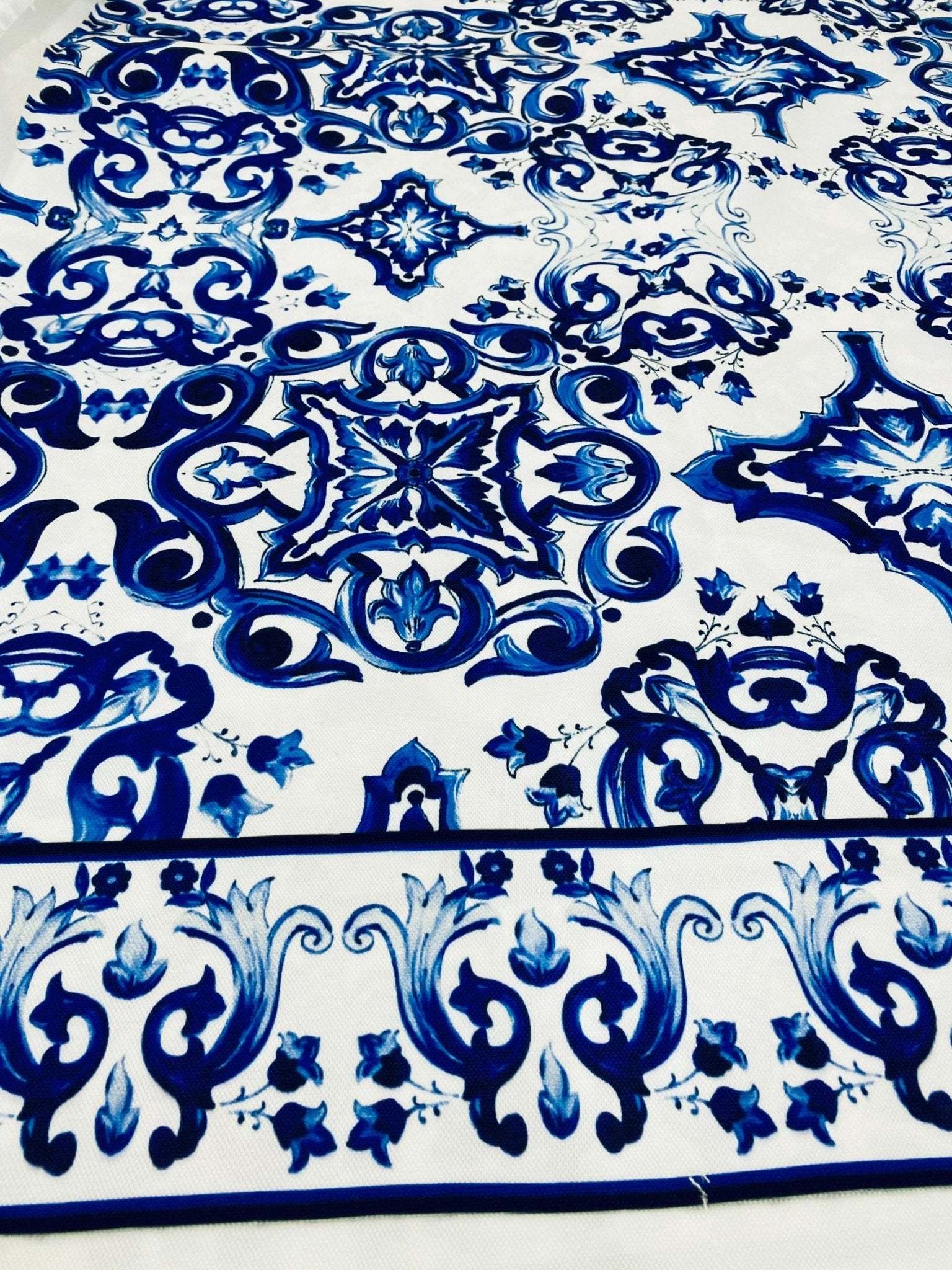 Close-up of durable Majolica pattern outdoor fabric in blue and white, weather-resistant upholstery material for outdoor furniture