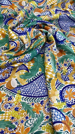 Mediterranean tile print fabric with vibrant blue, green, yellow, and orange patterns, soft and durable textile for home décor and crafts