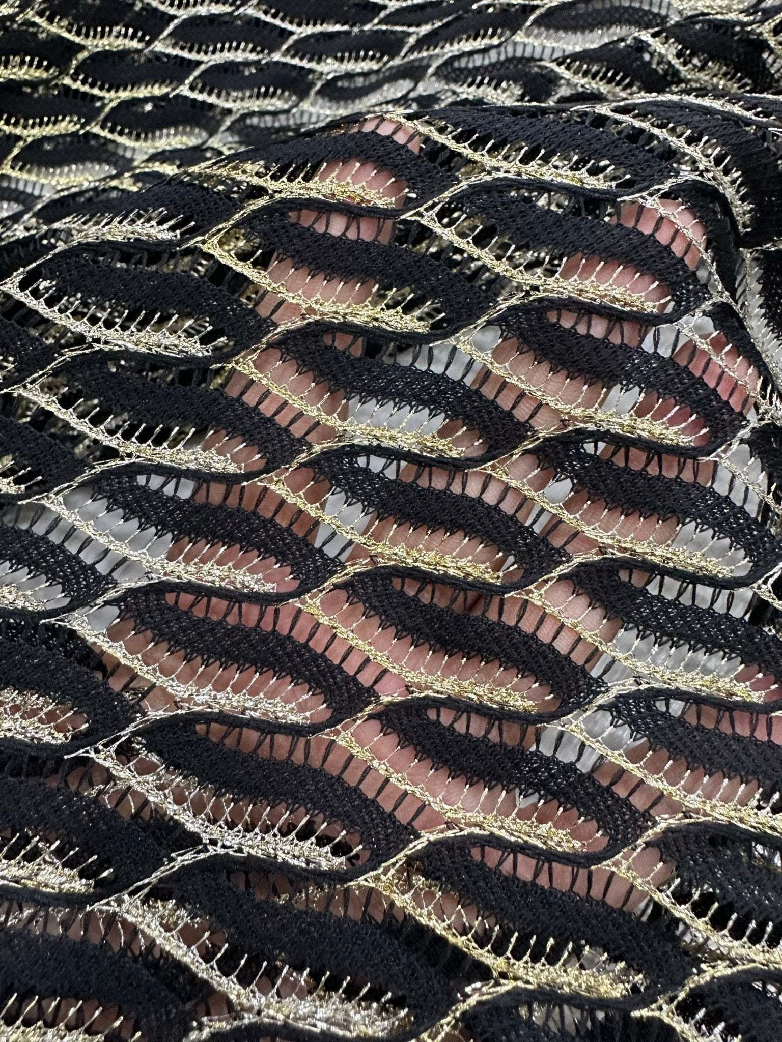 Black zigzag mesh lace fabric with intricate pattern for elegant fashion designs