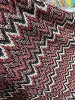 Bordeaux zigzag mesh knit jersey fabric with shiny textured pattern in burgundy and black tones
