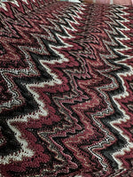 Bordeaux zigzag mesh knit jersey fabric with textured pattern in burgundy, black, and white tones