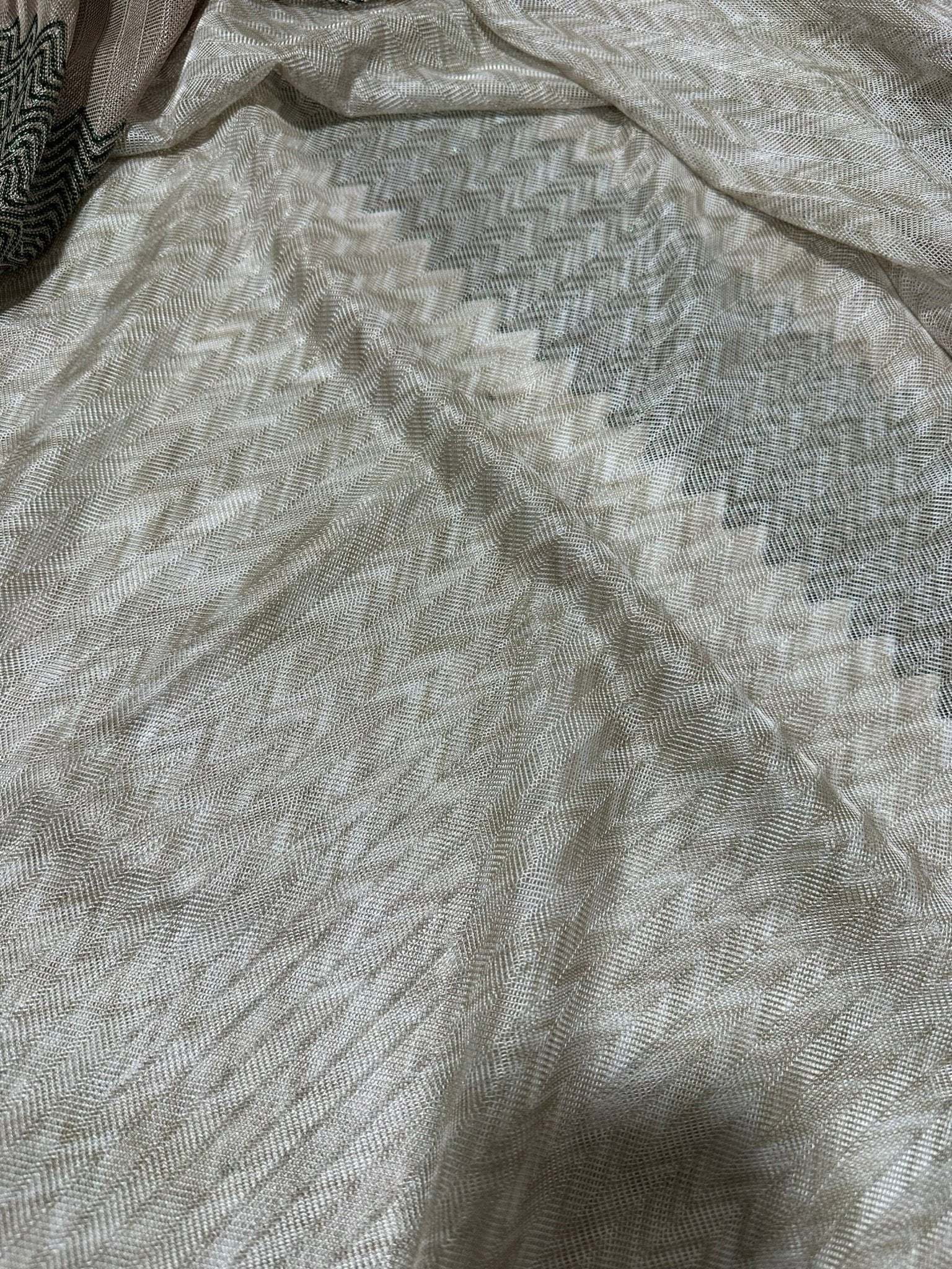 Gray zigzag knit jersey fabric with subtle textured pattern and soft drape