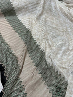 Gray zigzag knit jersey fabric with green glitter breathable mesh material in a continuous length for stylish garments