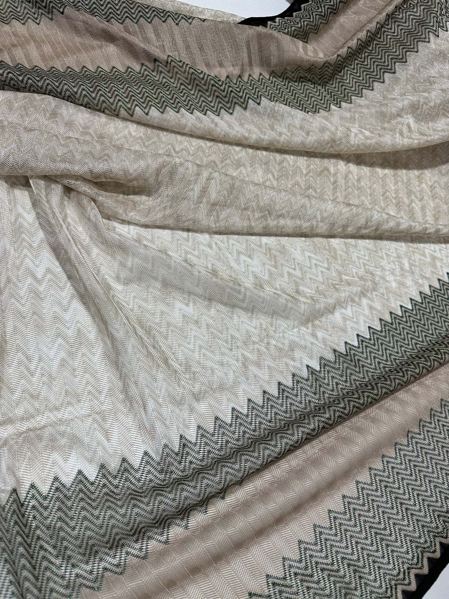 Gray zigzag knit jersey fabric with green glitter breathable mesh material and zigzag border pattern