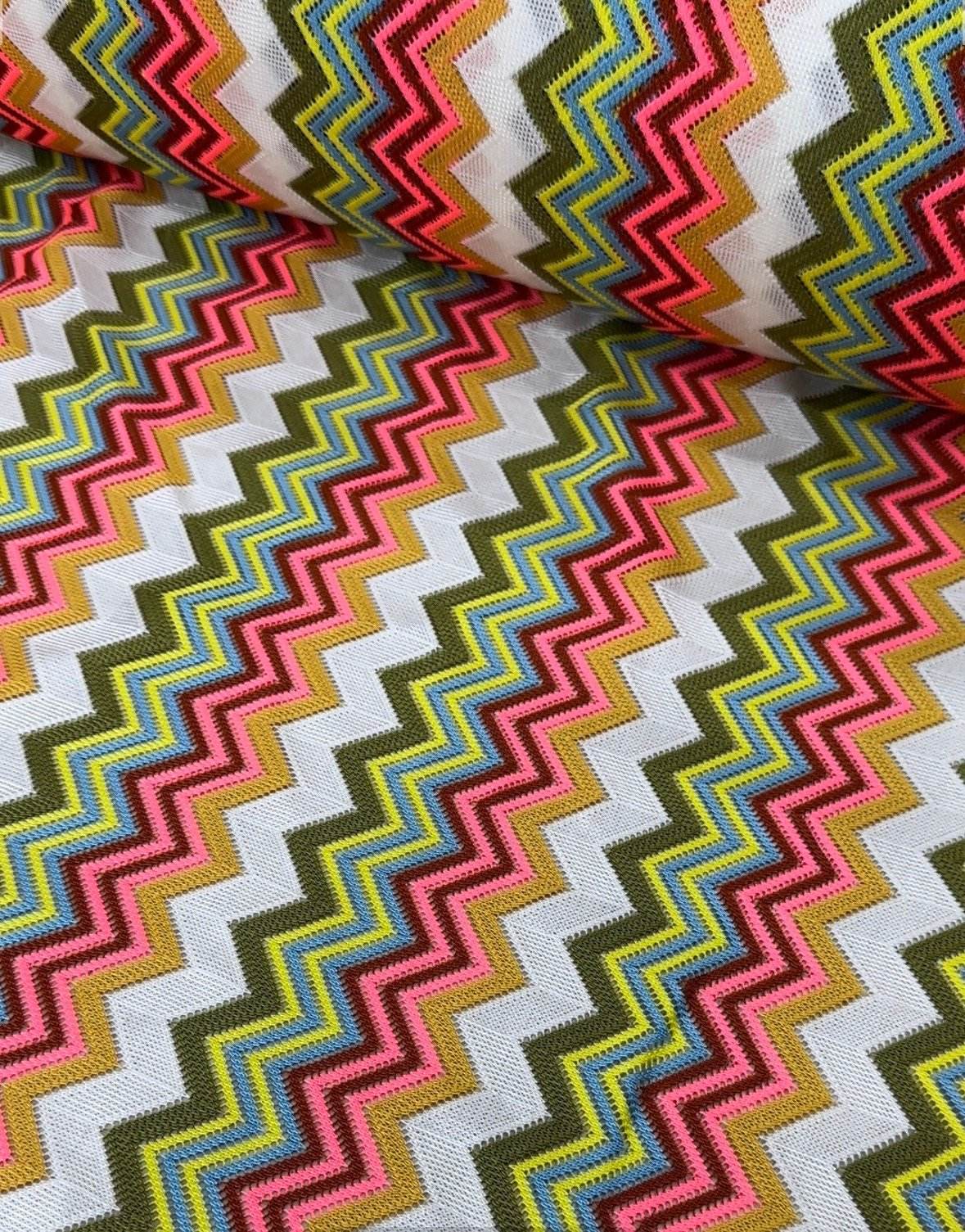 Multicolor zigzag knit jersey mesh fabric with vibrant zigzag pattern for crafting and apparel projects