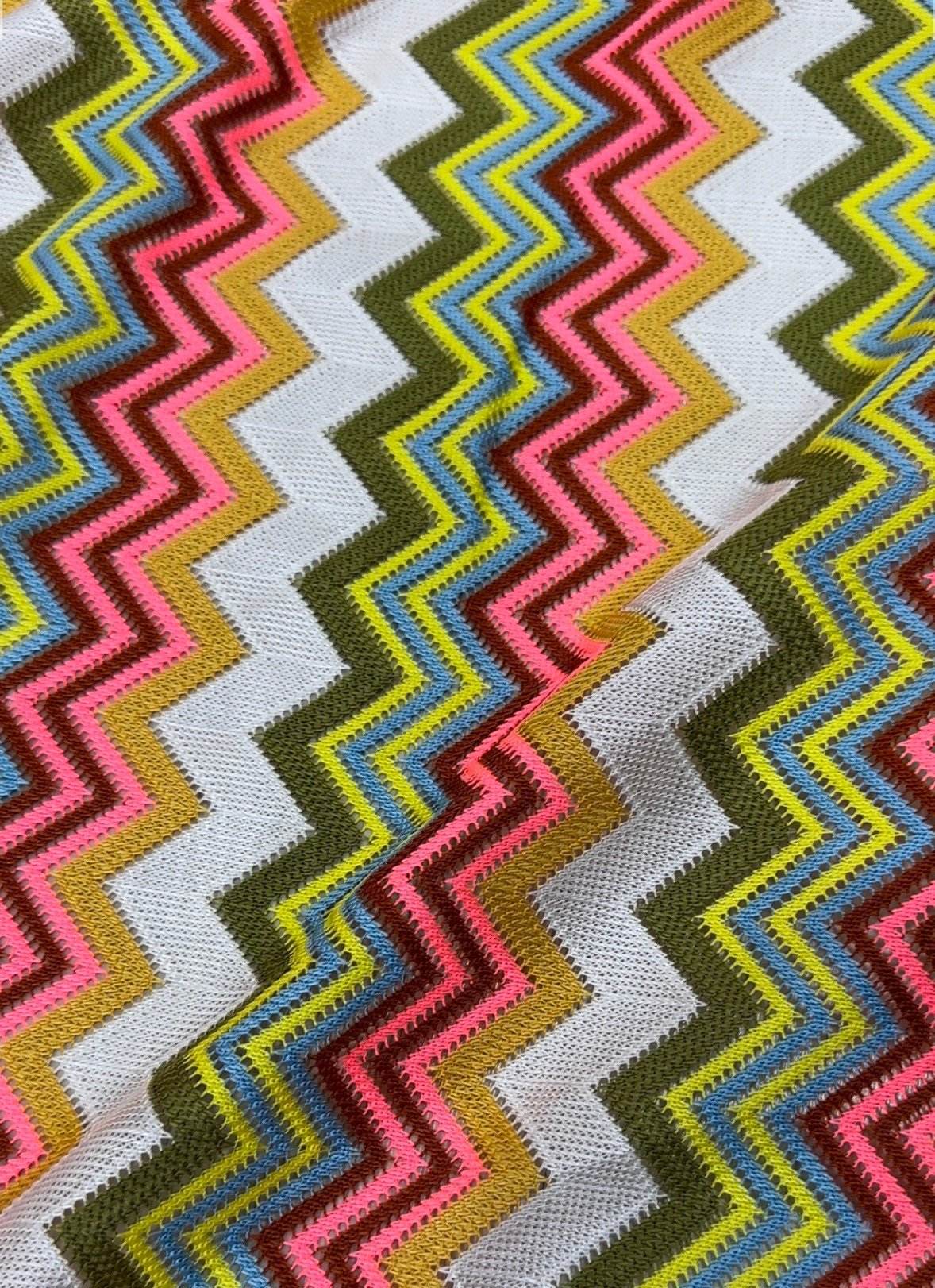 Multicolor zigzag knit jersey mesh fabric with vibrant zigzag pattern for crafting and apparel projects