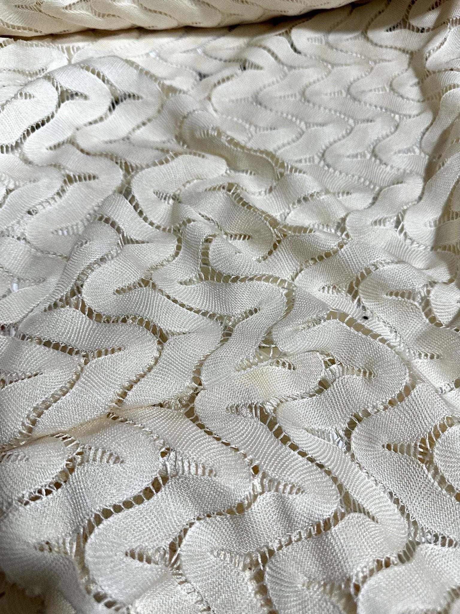 Off-White zigzag knit jersey fabric in breathable mesh with textured pattern for sewing projects
