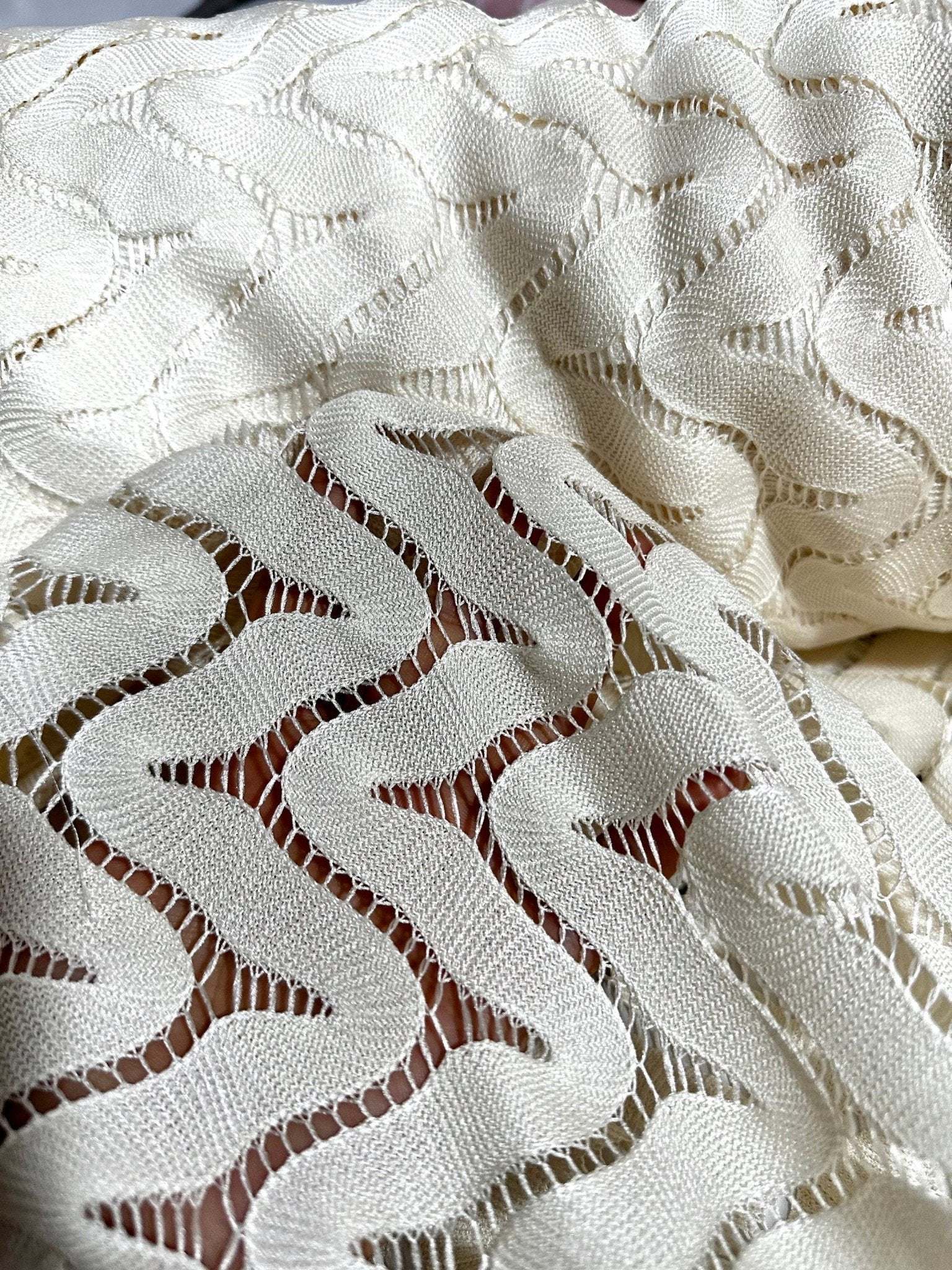 Off-White Zigzag Knit Jersey Fabric in mesh design with a lightweight, breathable texture and modern zigzag pattern