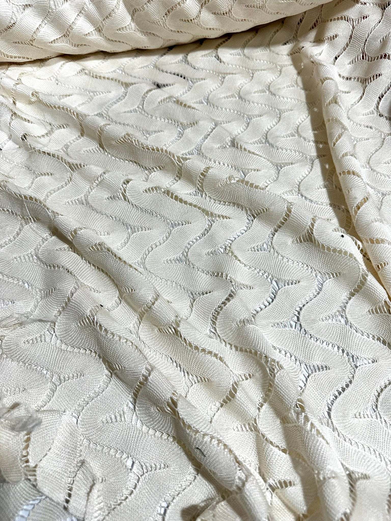 Off-White zigzag knit jersey fabric in breathable mesh with a modern pattern and soft texture.