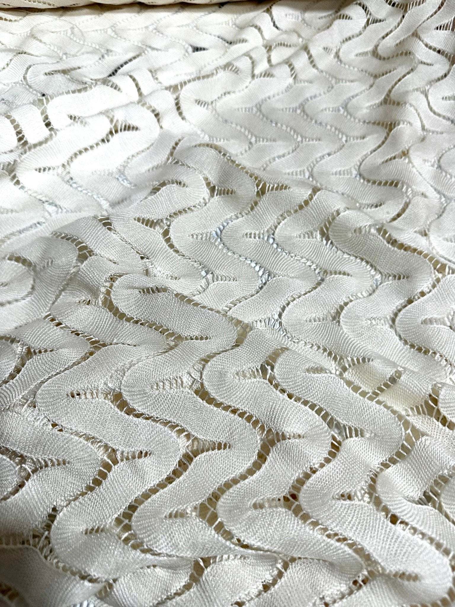 Off-White zigzag knit jersey fabric in mesh with modern pattern and breathable texture