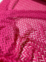 Pink zigzag knit jersey mesh fabric with intricate pattern for sewing and crafting projects