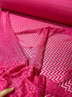Pink zigzag knit jersey fabric with mesh texture, ideal for sewing and crafting projects