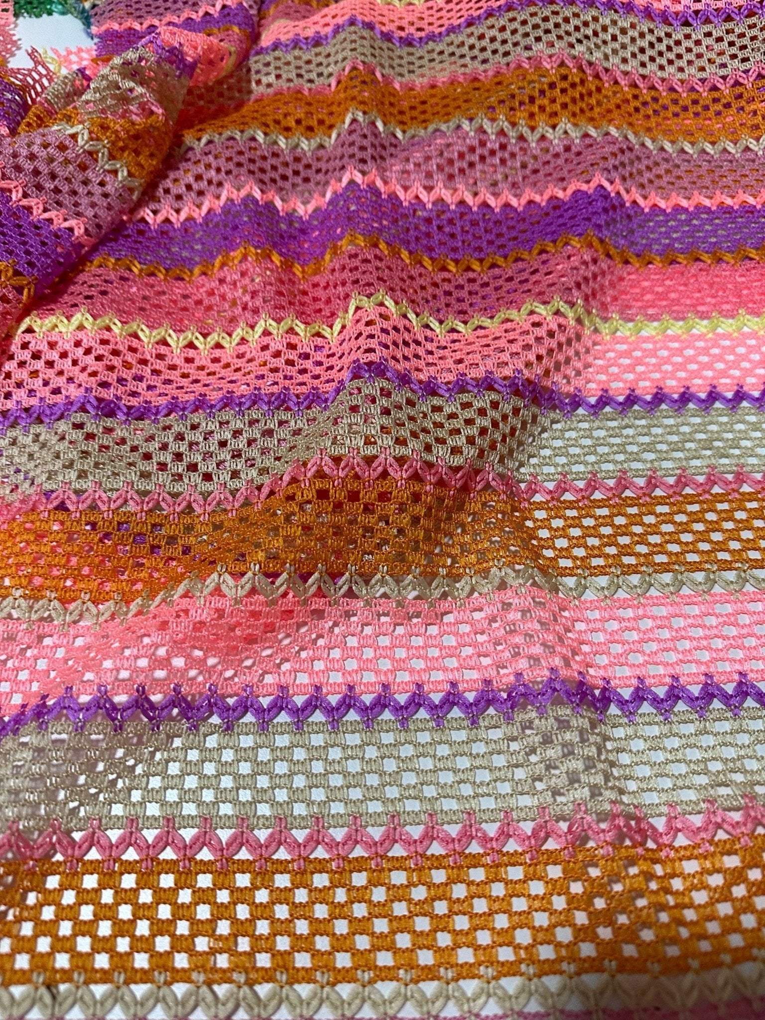 Pink striped knit jersey fabric with vibrant mesh texture and colorful horizontal stripes