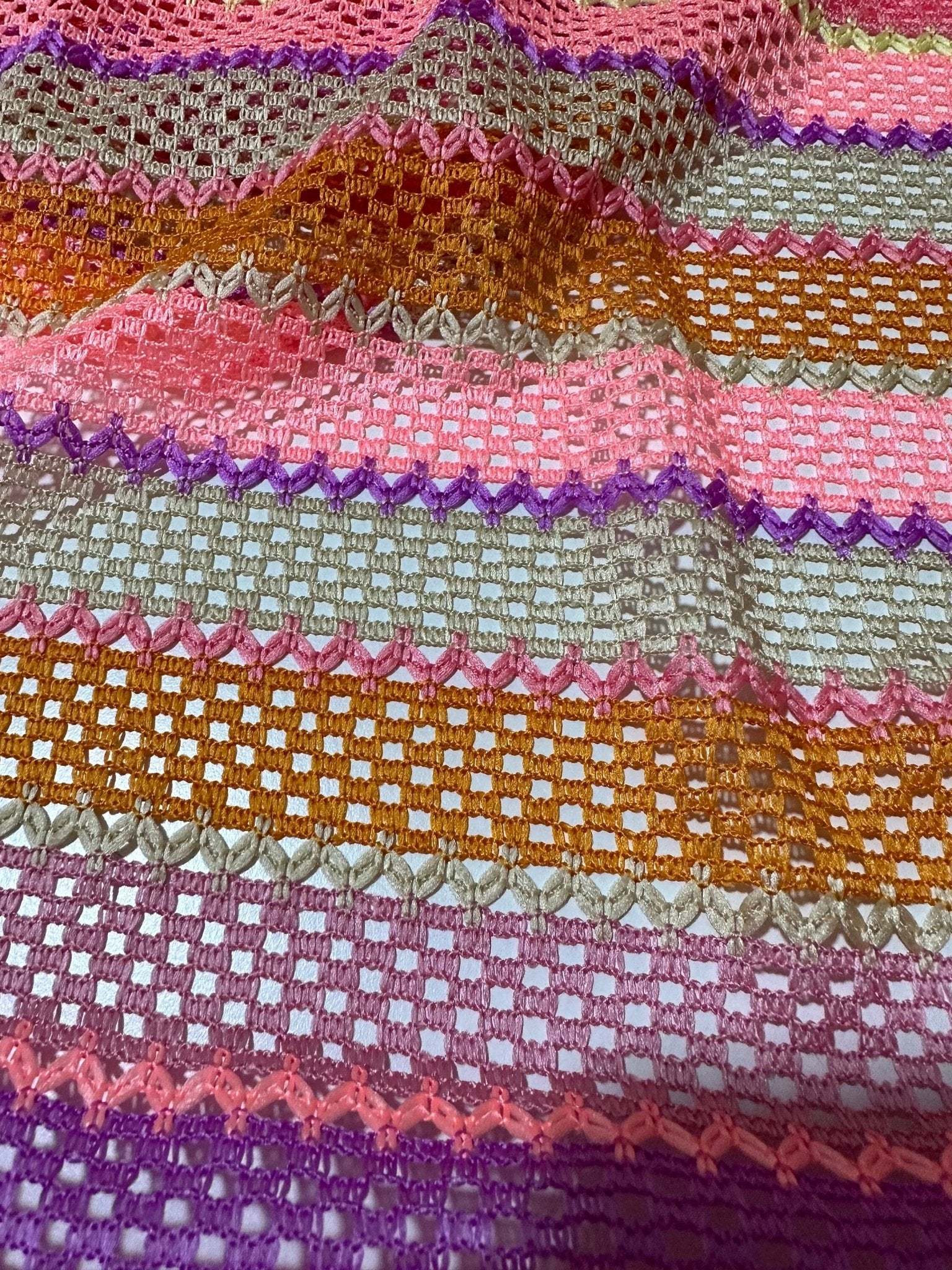 pink striped knit jersey fabric with mesh texture and vibrant horizontal stripes