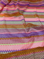 Pink striped knit jersey fabric with soft mesh texture and colorful horizontal stripes in pink, purple, orange, and green tones