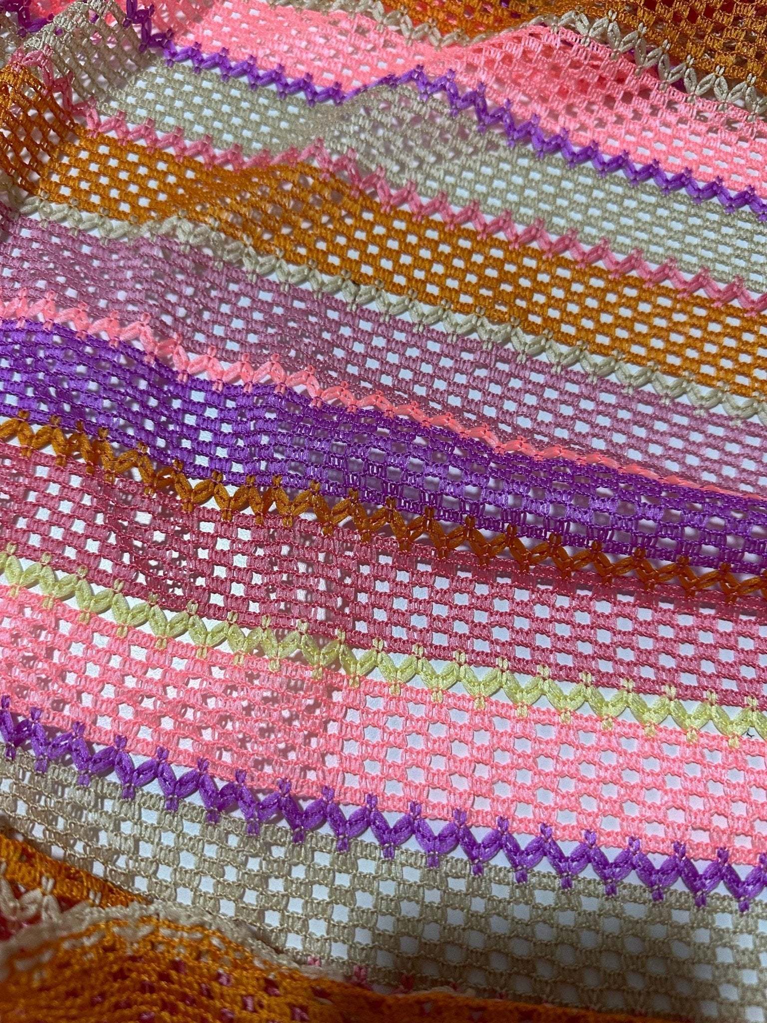 Pink striped knit jersey fabric with breathable mesh texture in vibrant colors for fashion and craft projects