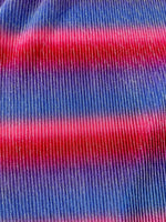 Close-up of pleated power mesh fabric with shiny threads in red and blue horizontal stripes