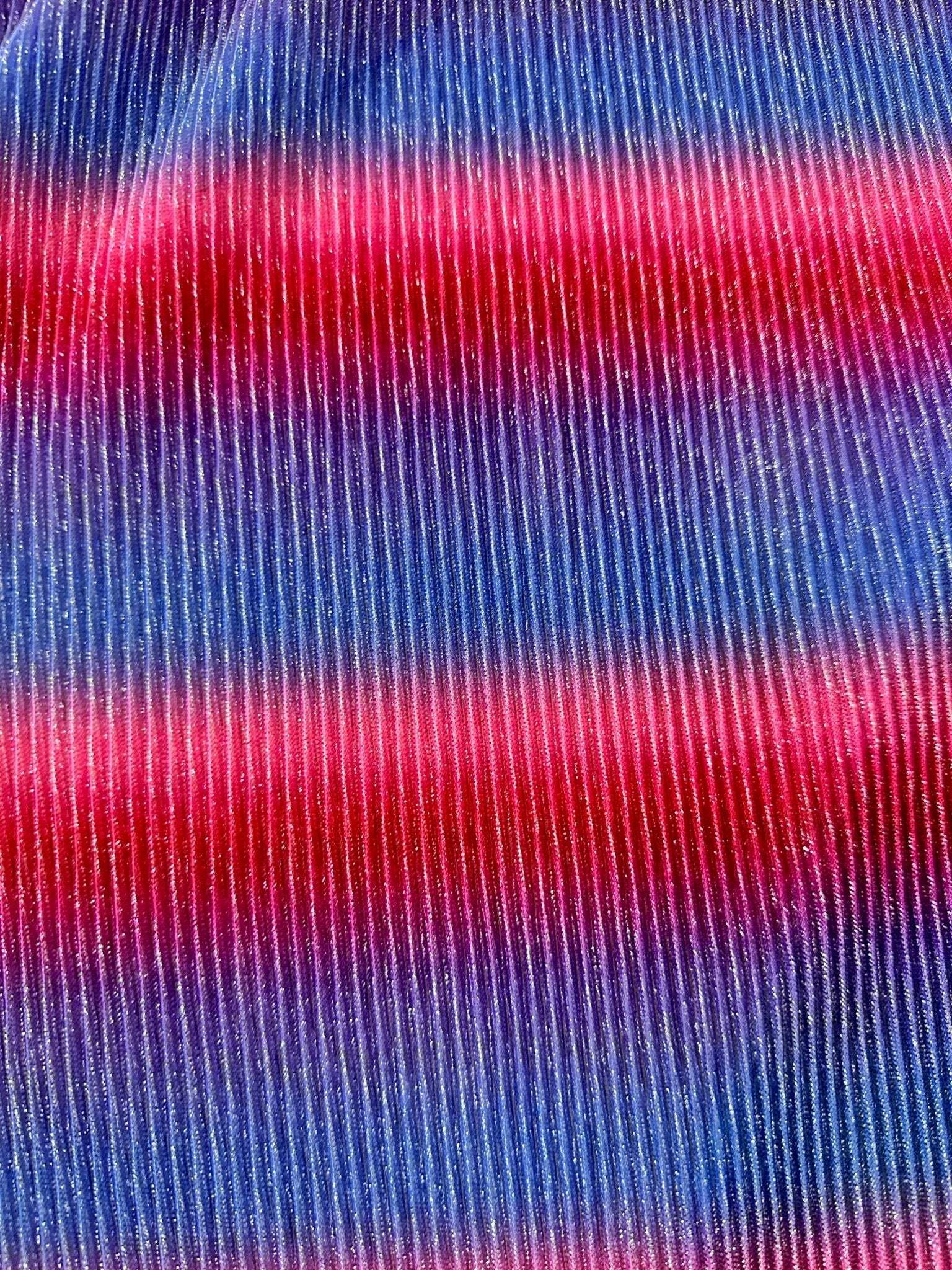 Close-up of pleated power mesh fabric with shiny threads in red and blue horizontal stripes