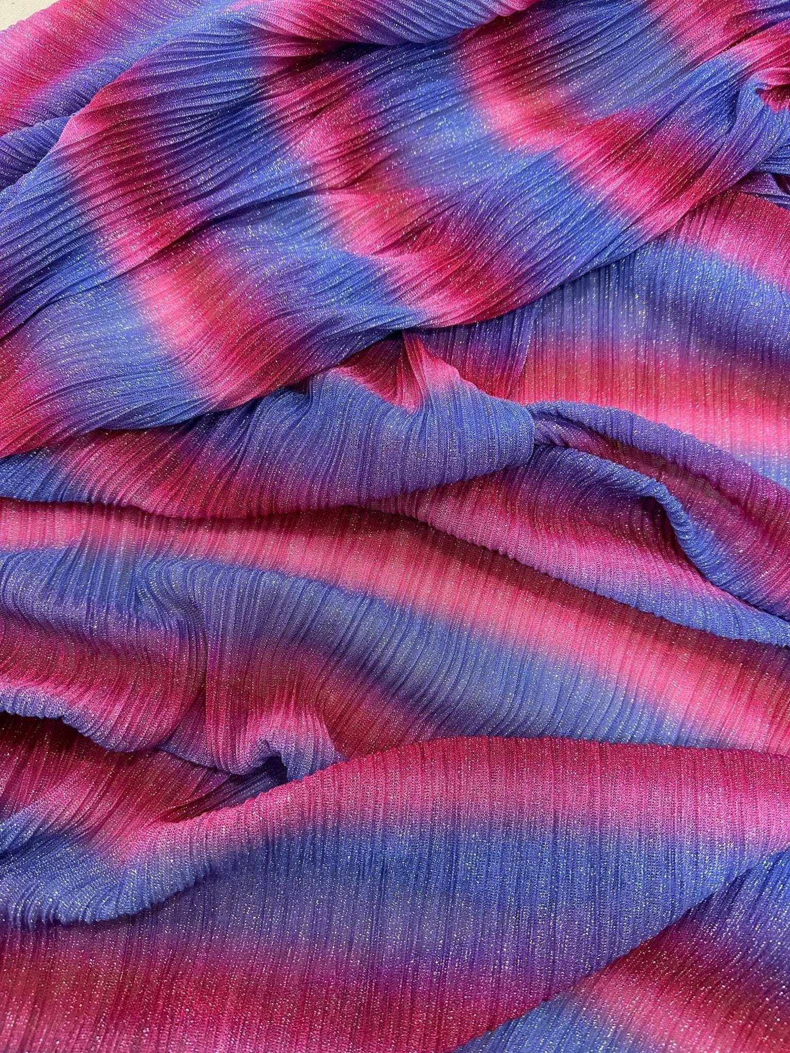 pleated power mesh fabric with shiny threads in red and blue gradient colors, lightweight and soft textured textile
