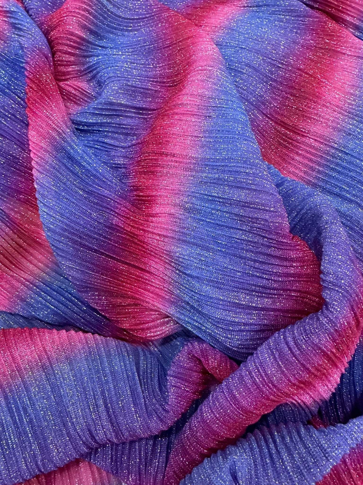 Pleated power mesh fabric with shiny threads in pink and purple hues, lightweight and soft texture