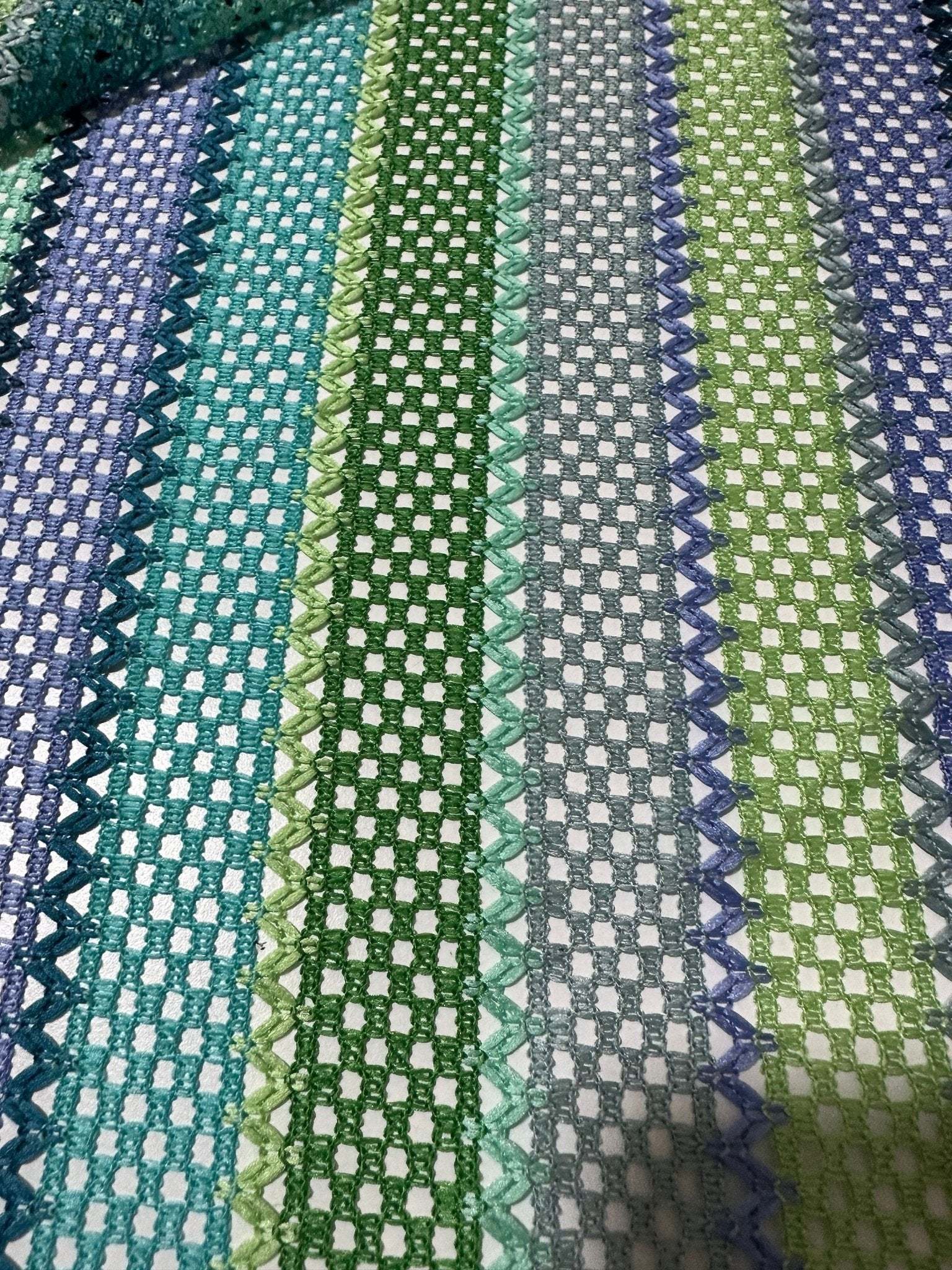 Striped knit mesh fabric with green and blue zigzag pattern for creative sewing projects