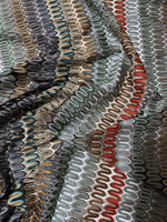 close-up of colorful mesh zigzag knit jersey fabric with textured pattern and waves