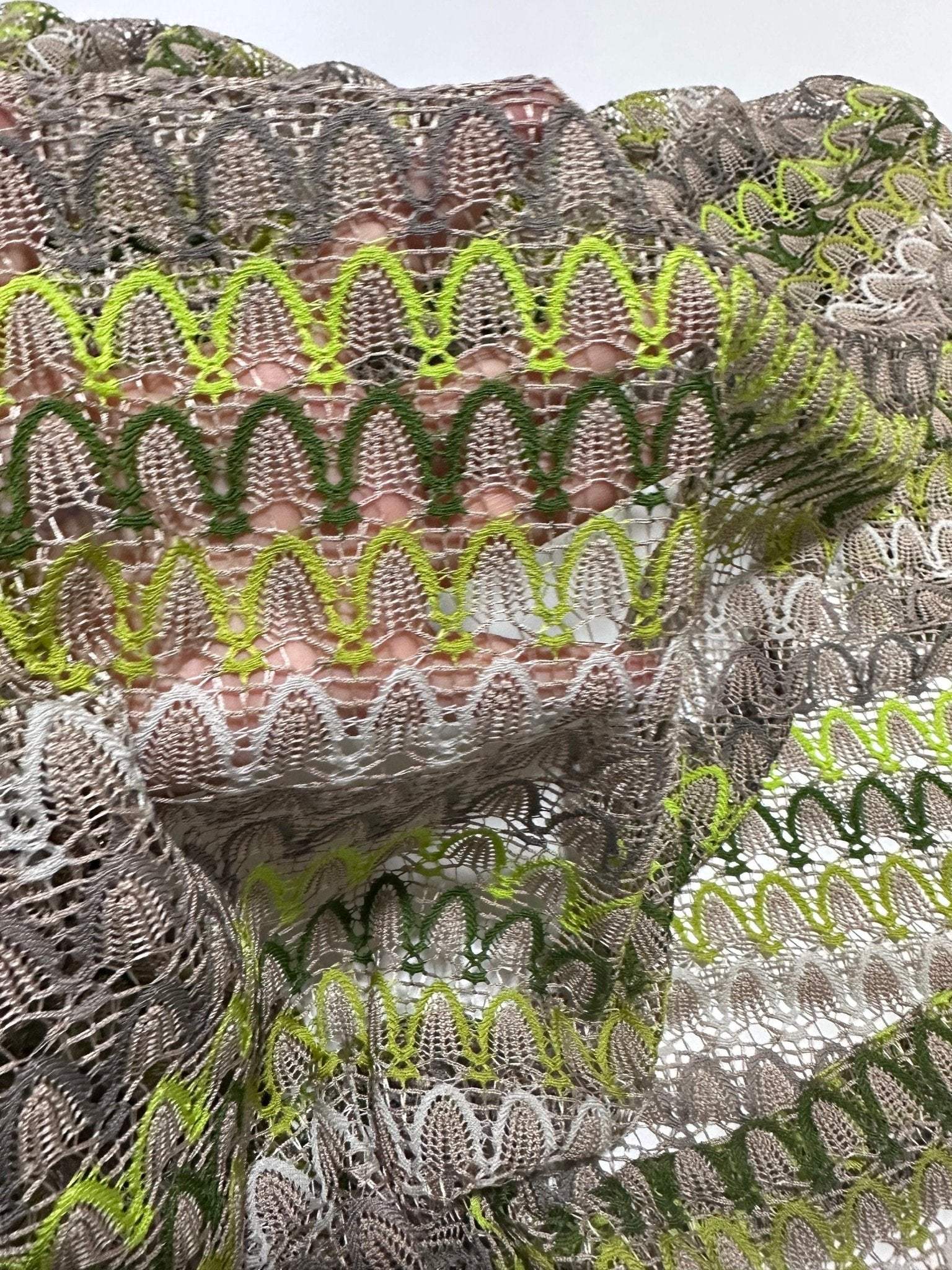 Beige green zigzag knit jersey mesh fabric with soft stretchy texture for clothing and crafts