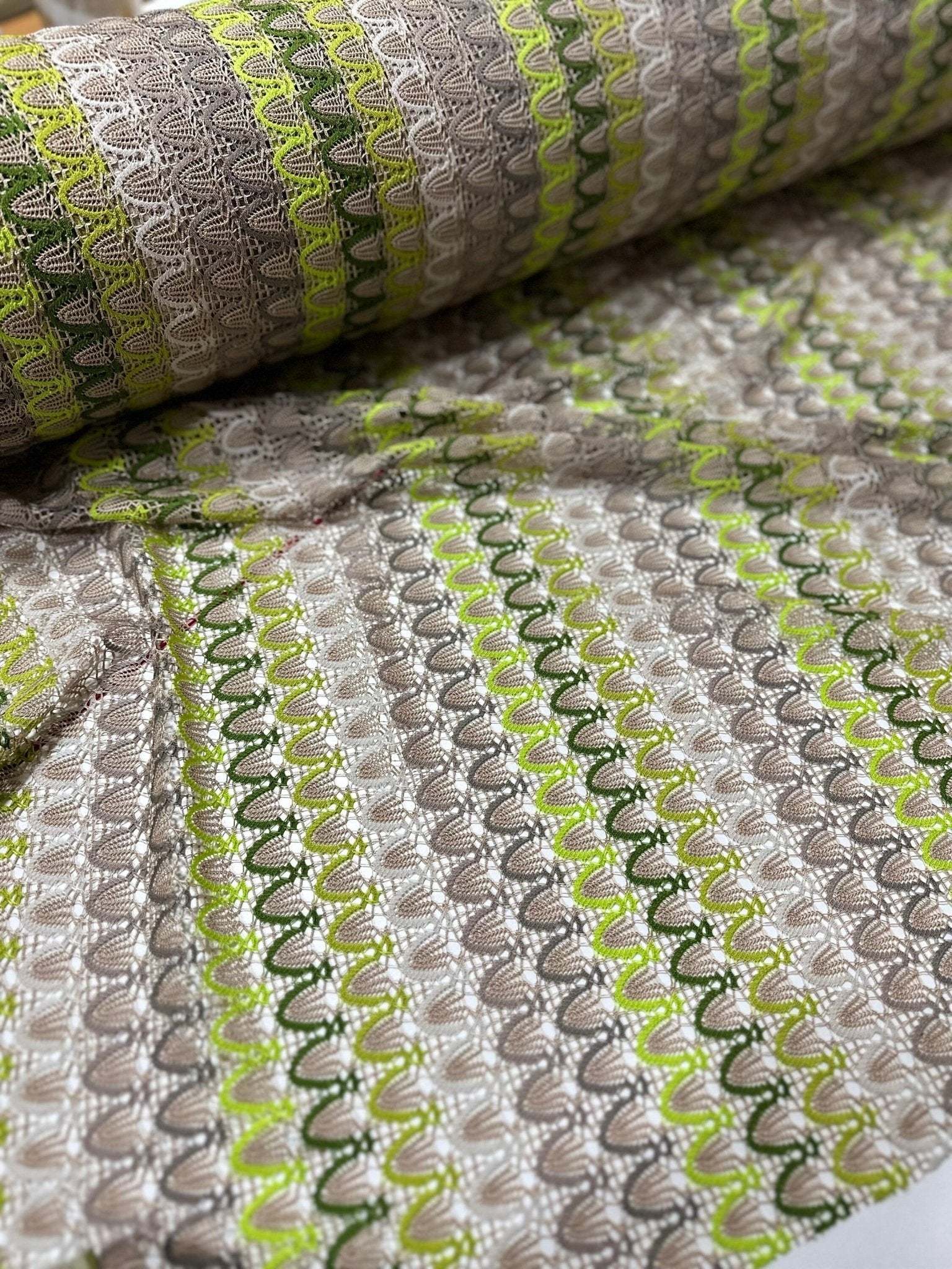 Beige green zigzag knit jersey mesh fabric with soft stretchy texture for clothing and crafts