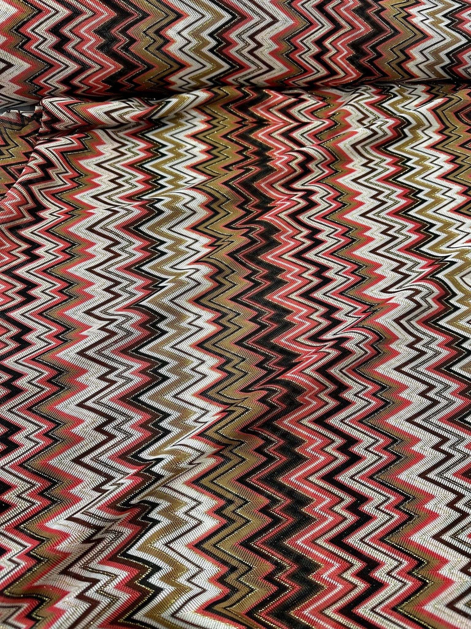 Coral zigzag knit jersey fabric with luxury mesh Italian design in coral, white, black, and olive tones