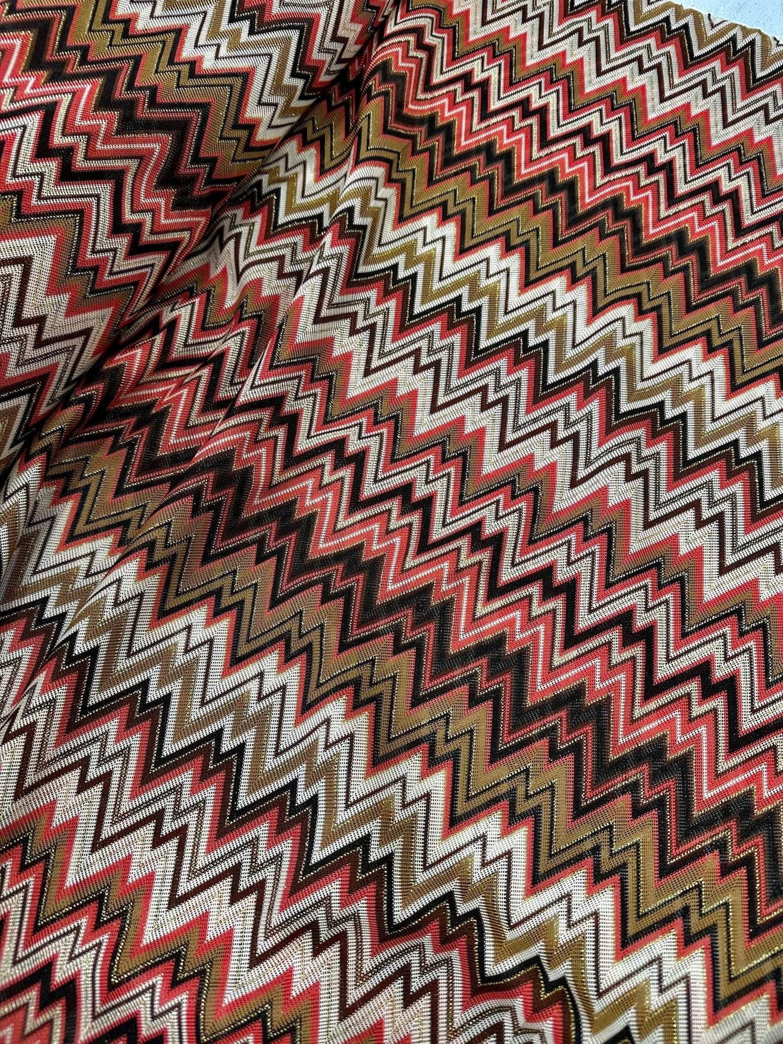 Coral zigzag knit jersey fabric with luxury mesh Italian design in coral, brown, and beige tones