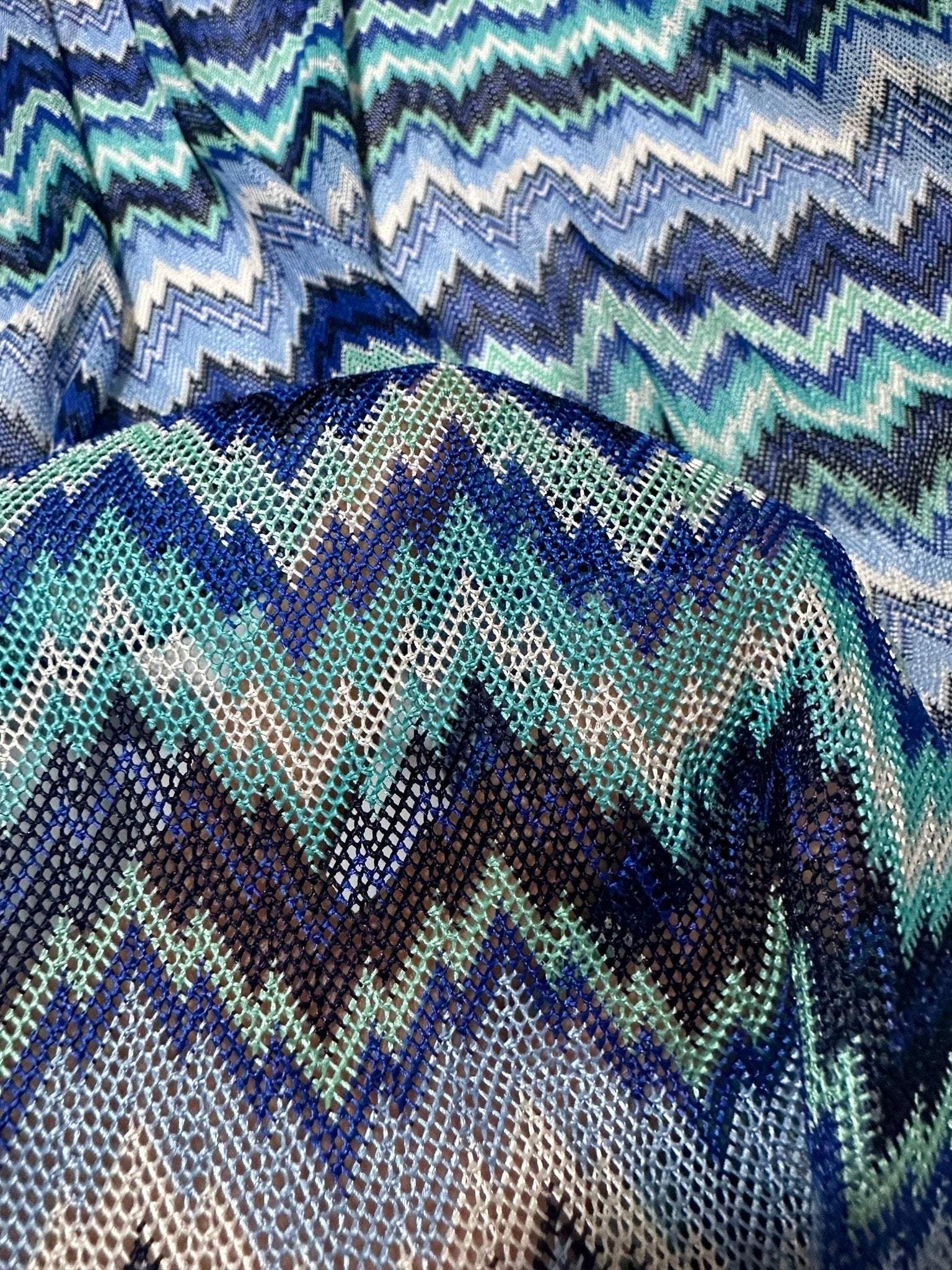 Zigzag knitted mesh fabric with blue and white chevron pattern and soft stretch texture