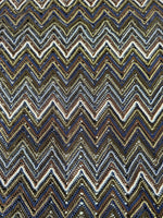shimmering zigzag knitted mesh fabric with elastic jersey texture in gold, blue, and black tones