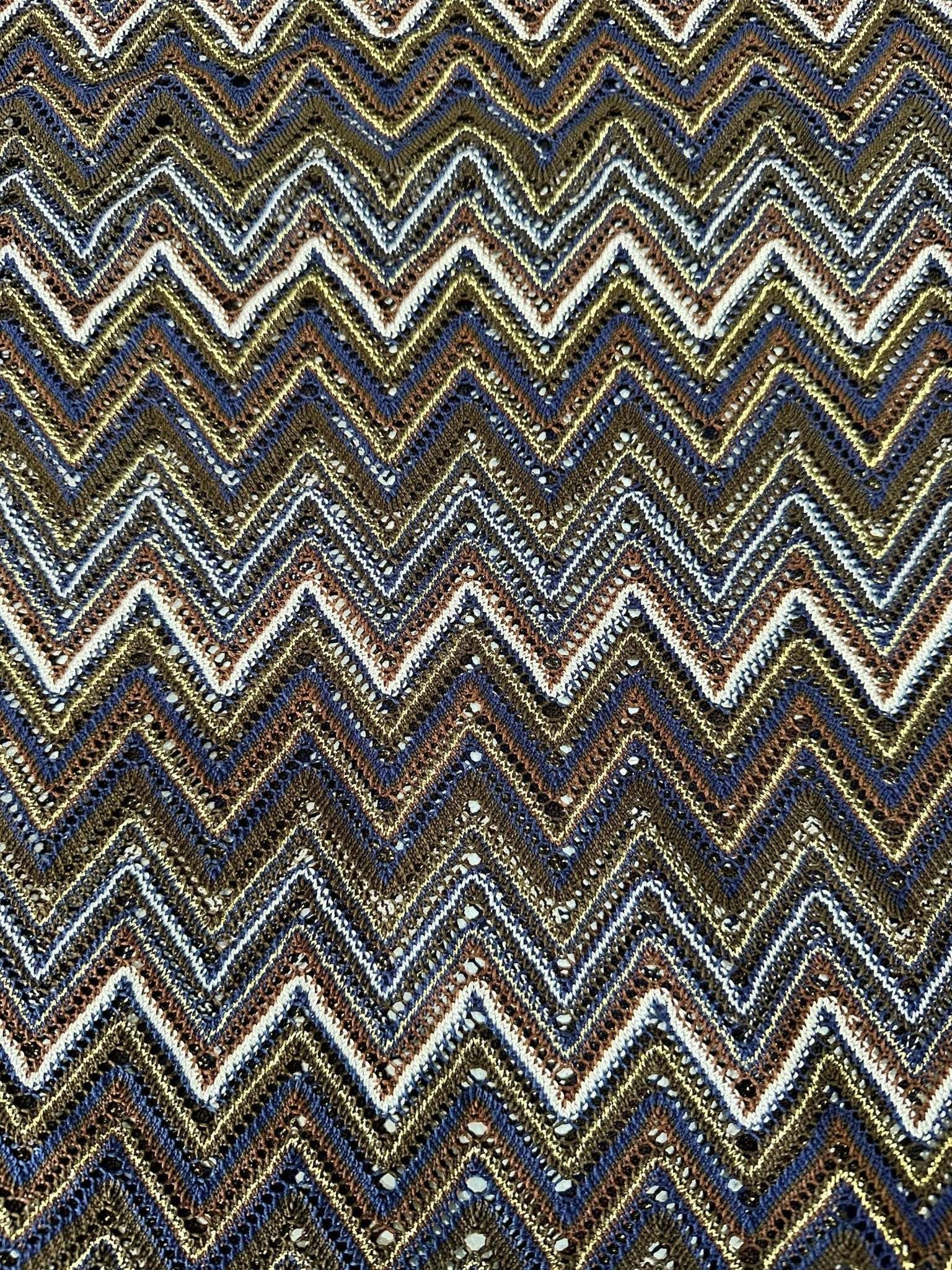 shimmering zigzag knitted mesh fabric with elastic jersey texture in gold, blue, and black tones