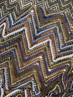 Shimmering zigzag knitted mesh fabric with elastic stretch and intricate pattern for stylish garments