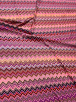 Close-up of colorful zigzag mesh stretch fabric with 4-way stretch and 150cm width