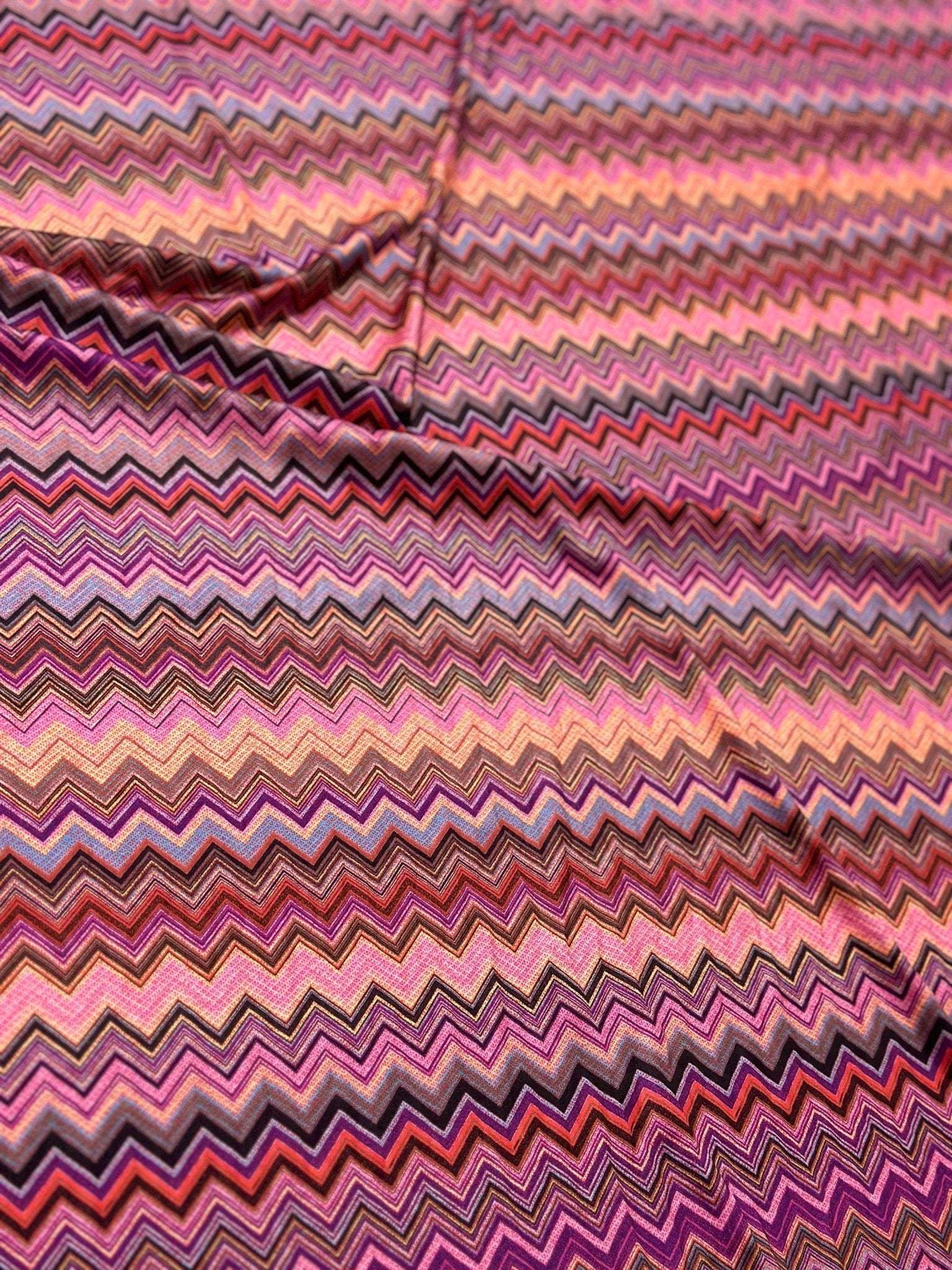 Close-up of colorful zigzag mesh stretch fabric with 4-way stretch and 150cm width