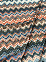 Close-up of colorful zigzag patterned fabric with 4-way stretch mesh texture and flexibility