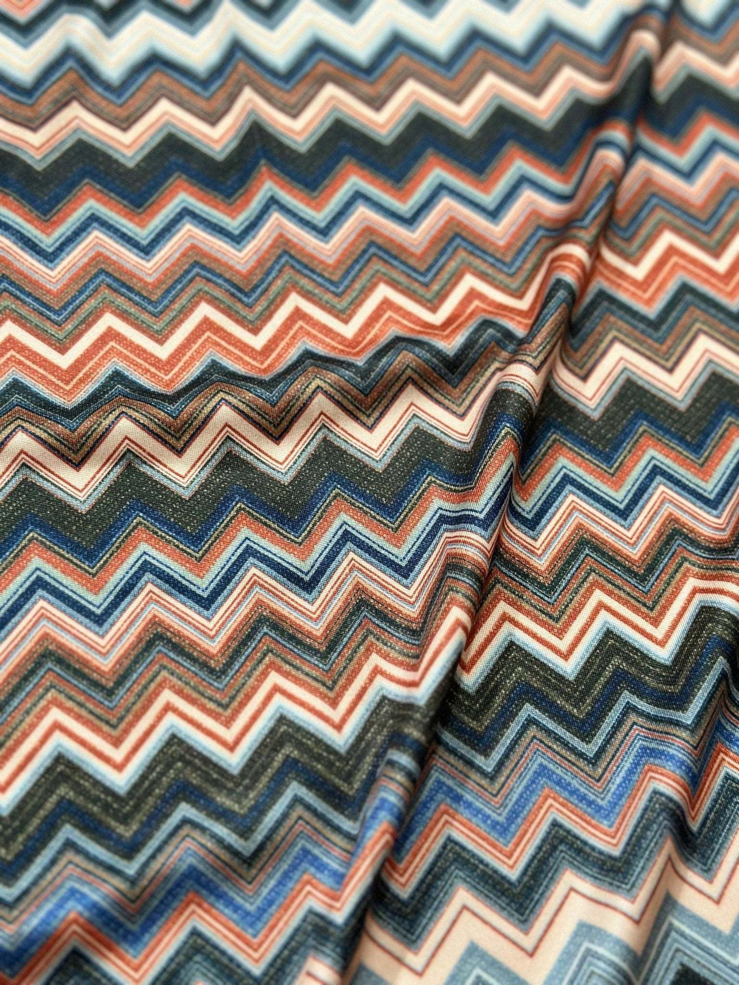 Close-up of colorful zigzag patterned fabric with 4-way stretch mesh texture and flexibility