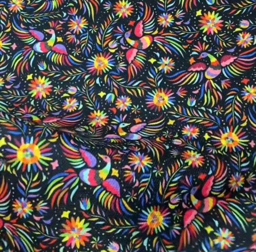 Vibrant Otomi pattern upholstery fabric with colorful birds and floral designs on black background, 150cm width.