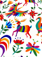 Colorful Otomi print fabric with vibrant birds, deer, flowers, and insects on white background for outdoor pillow use