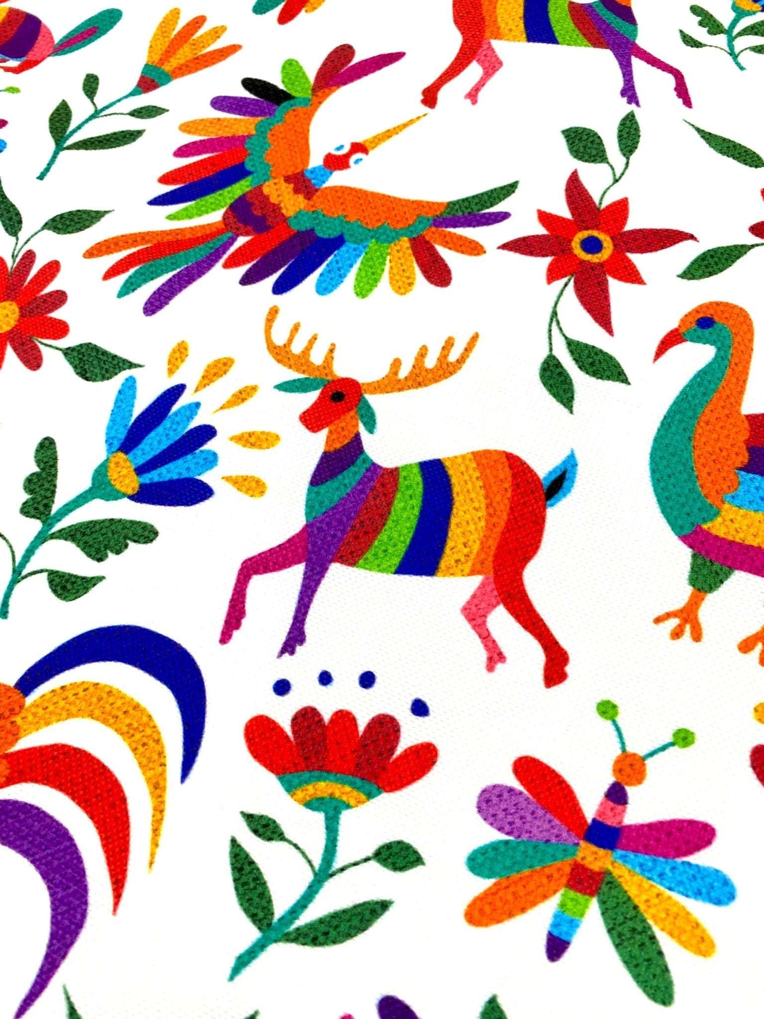 Colorful Otomi print fabric with vibrant birds, deer, flowers, and insects on white background for outdoor pillow use