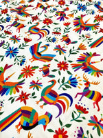 Colorful Otomi print fabric with birds and flowers on white background, suitable for outdoor pillows and upholstery
