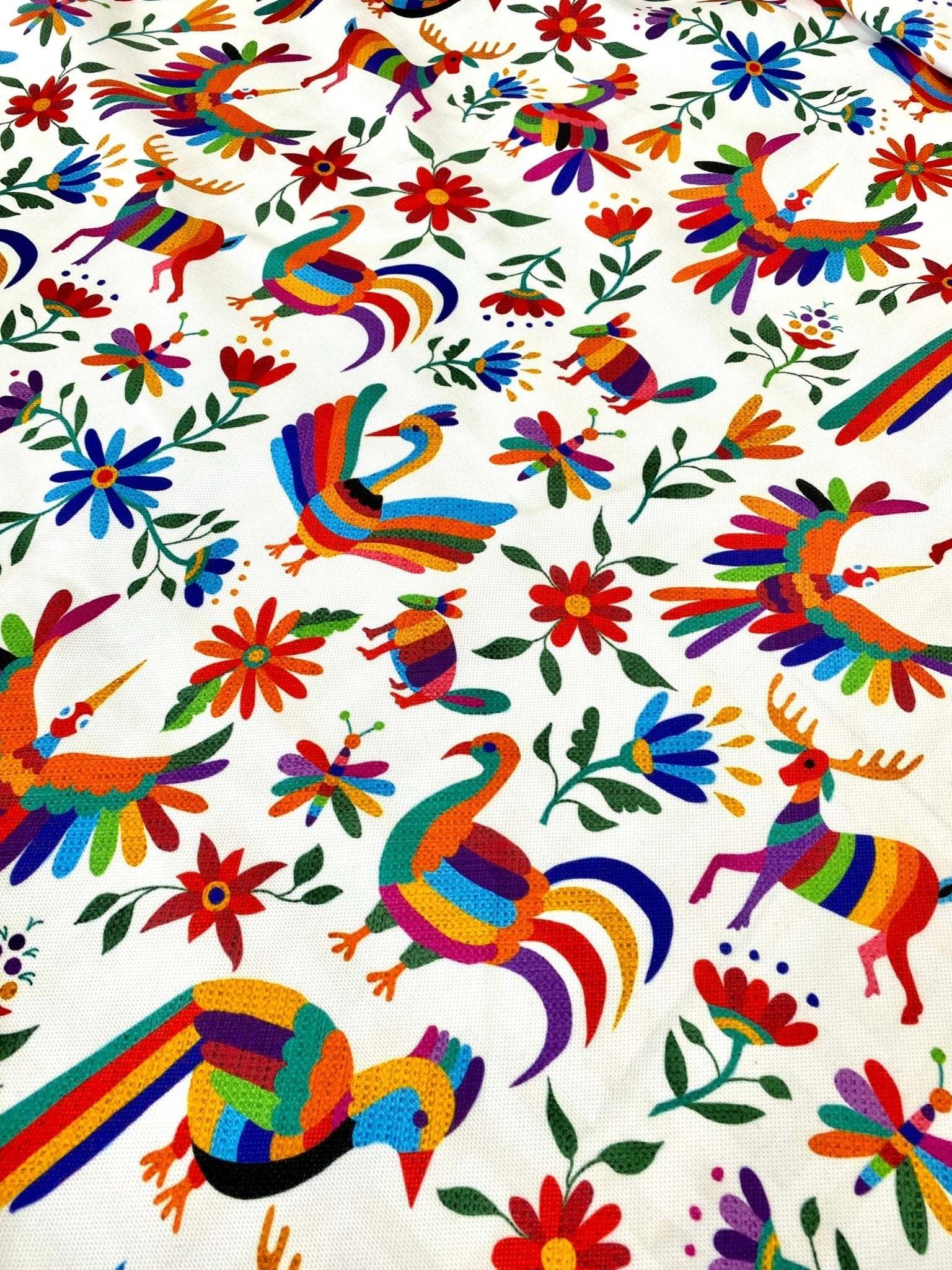 Colorful Otomi print fabric with birds and flowers on white background, suitable for outdoor pillows and upholstery